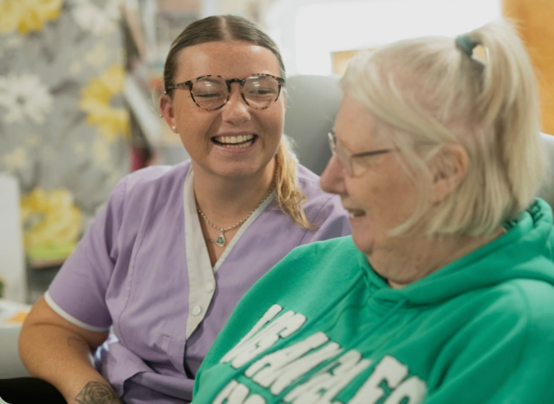 Caregiver sharing a moment with a senior resident
